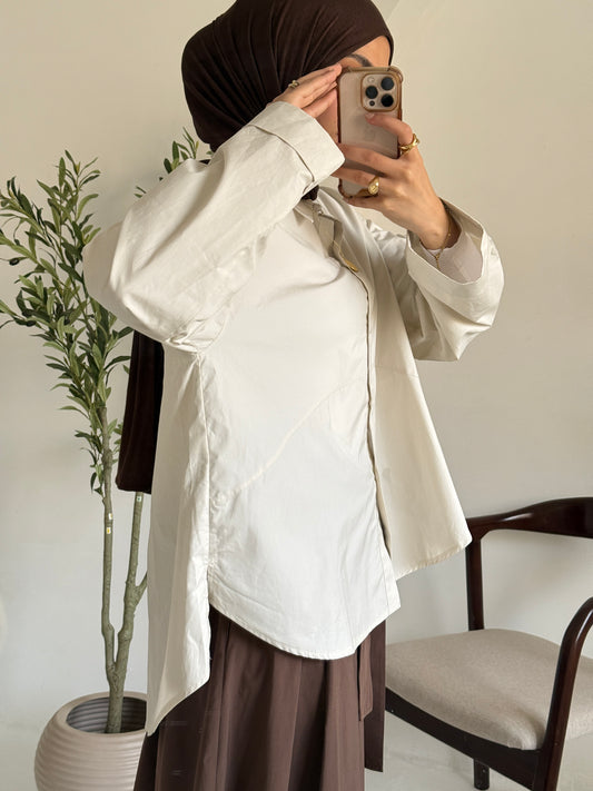 Amenaa oversized poplin shirt in a relaxed fit, featuring a crisp white fabric and classic collar, displayed on a hanger.