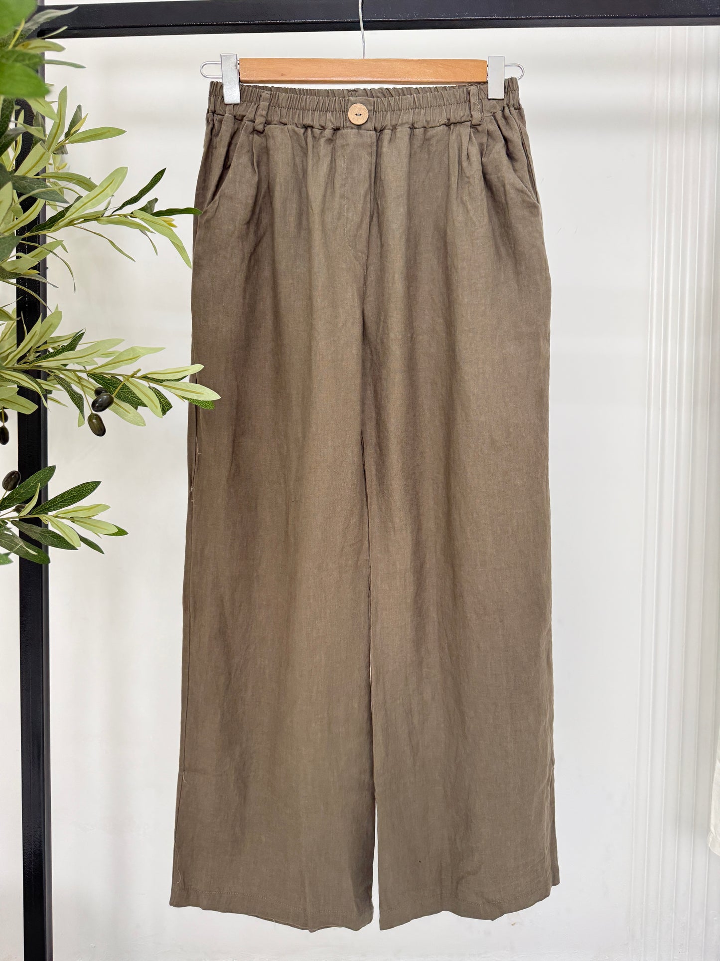 Light beige Amenaa summer linen pants with a relaxed fit, featuring a wide-leg design and adjustable waist for comfortable wear.