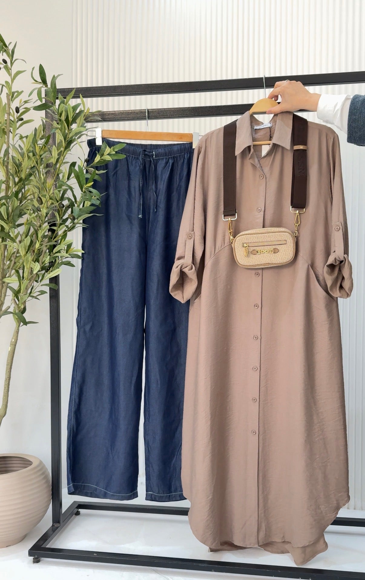 Amenaa tensile jeans showing a close-up of dark denim fabric with visible stitching and a classic five-pocket design.