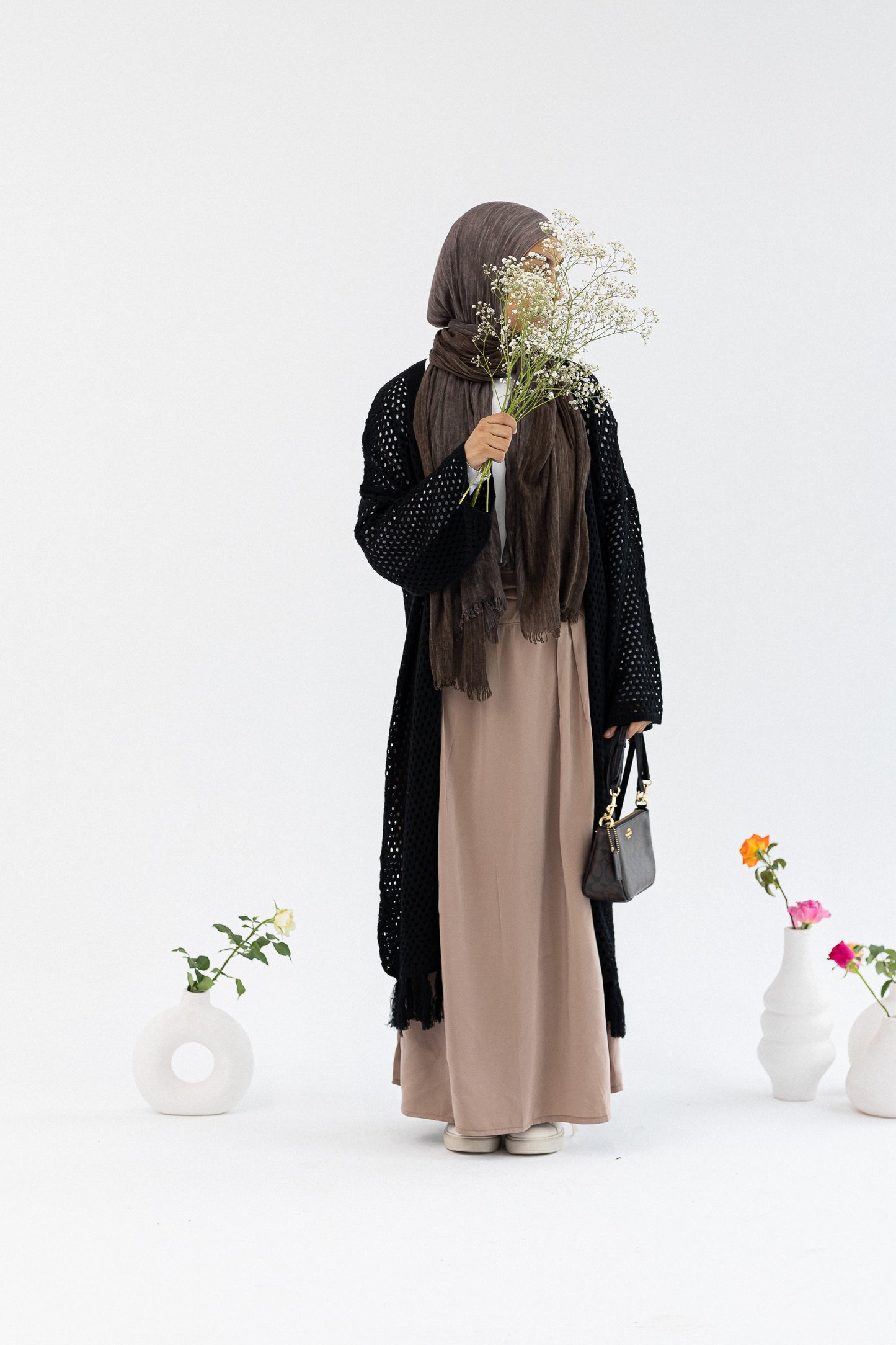 Crochet knit cardigan by Amenaa, featuring a cozy, textured design in neutral tones, perfect for casual or layered wear.