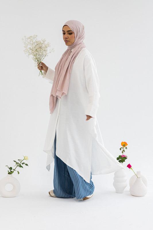 Amenaa high-low shirt dress featuring a flowing silhouette and button-front design, perfect for casual or semi-formal occasions.