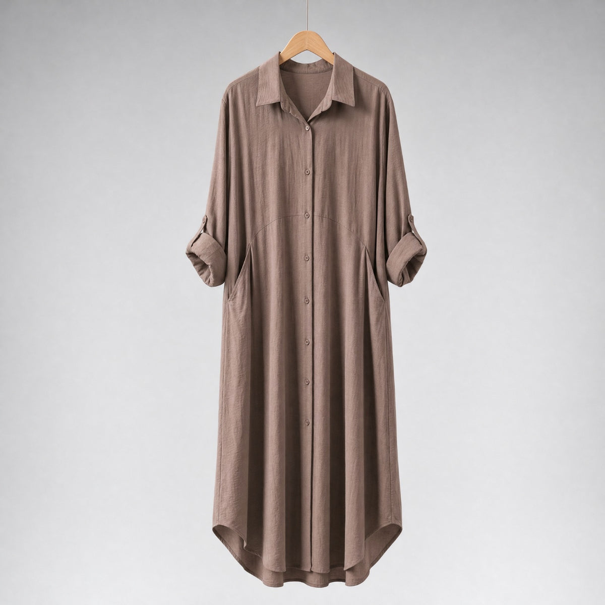 Amenaa shirt dress featuring a relaxed fit, button front, and short sleeves, displayed on a wooden hanger.