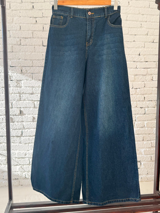 Amenaa denim wide-leg pants laid flat, showcasing their relaxed fit and classic blue denim fabric.
