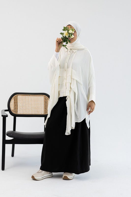 Amenaa ruffles blouse featuring soft fabric, feminine ruffle details, and a stylish, casual fit suitable for everyday wear.