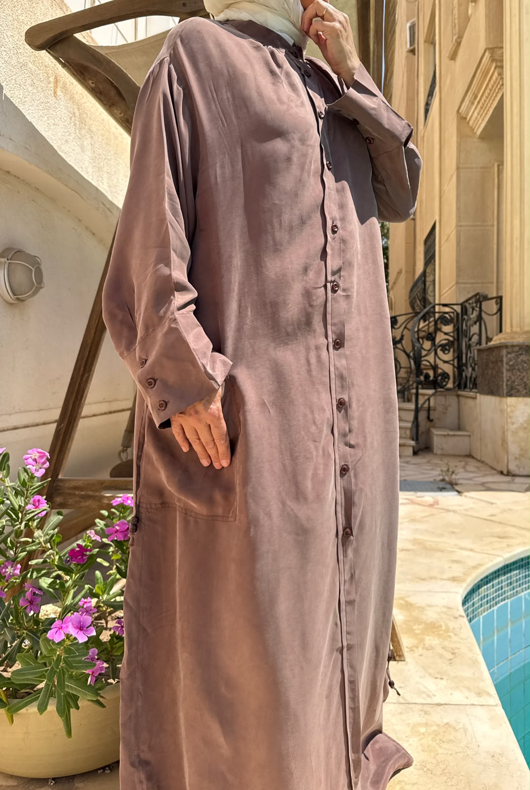 Amenaa modest abaya featuring elegant black fabric with subtle embroidery and a flowing, full-length design for women's modest fashion.