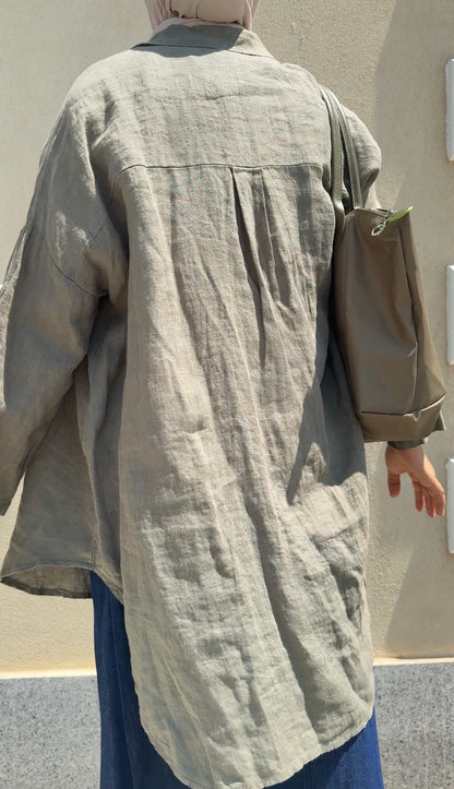 Light beige Amenaa linen shirt with long sleeves, collar, and button closure, displayed flat on a neutral background.