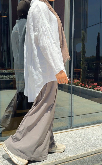 Amenaa linen shirt shown in light, breathable fabric with a relaxed fit and classic collar, styled for casual and summer wear.