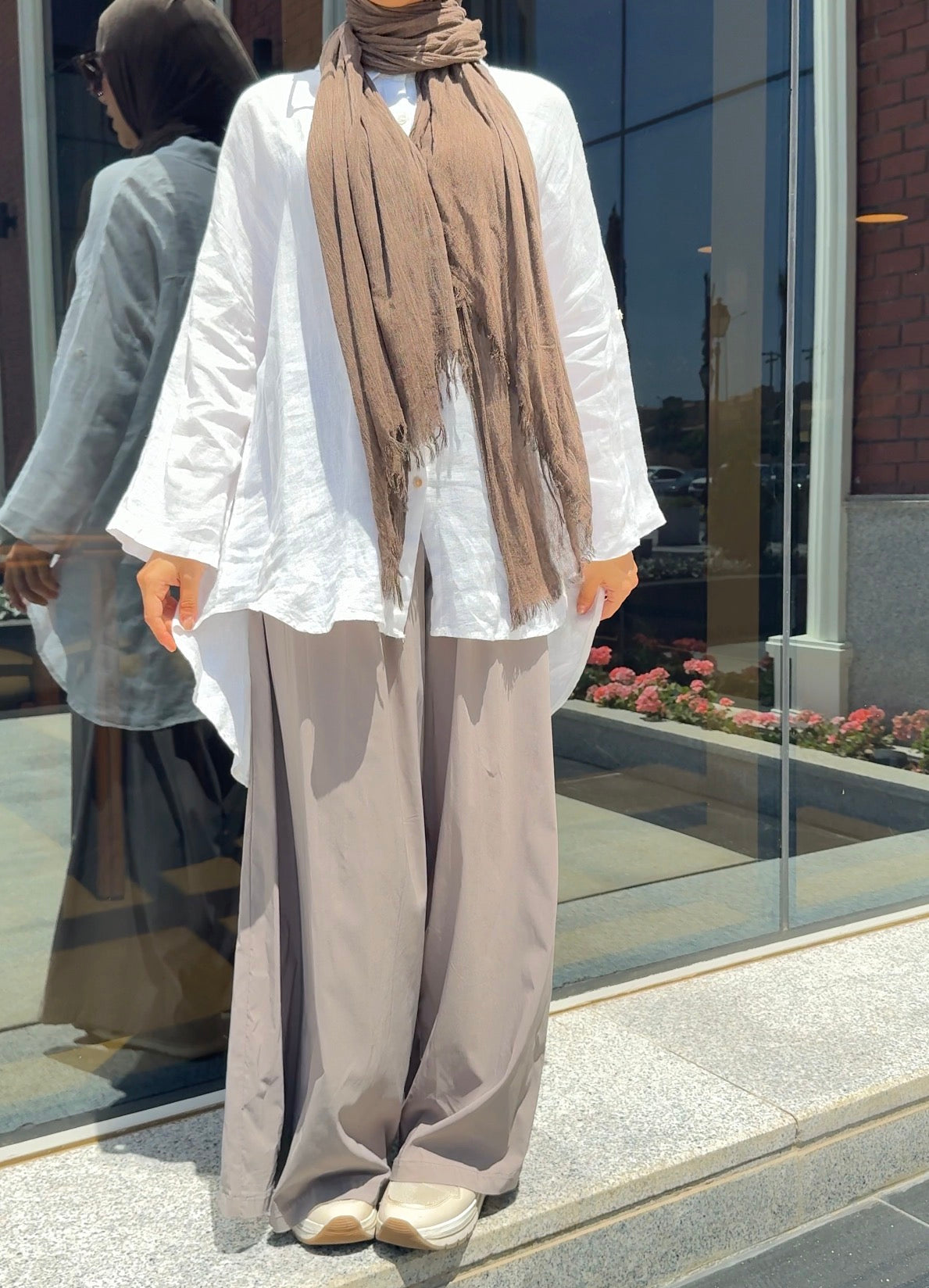 Light beige Amenaa linen shirt displayed flat, showing its relaxed fit and lightweight, breathable fabric.