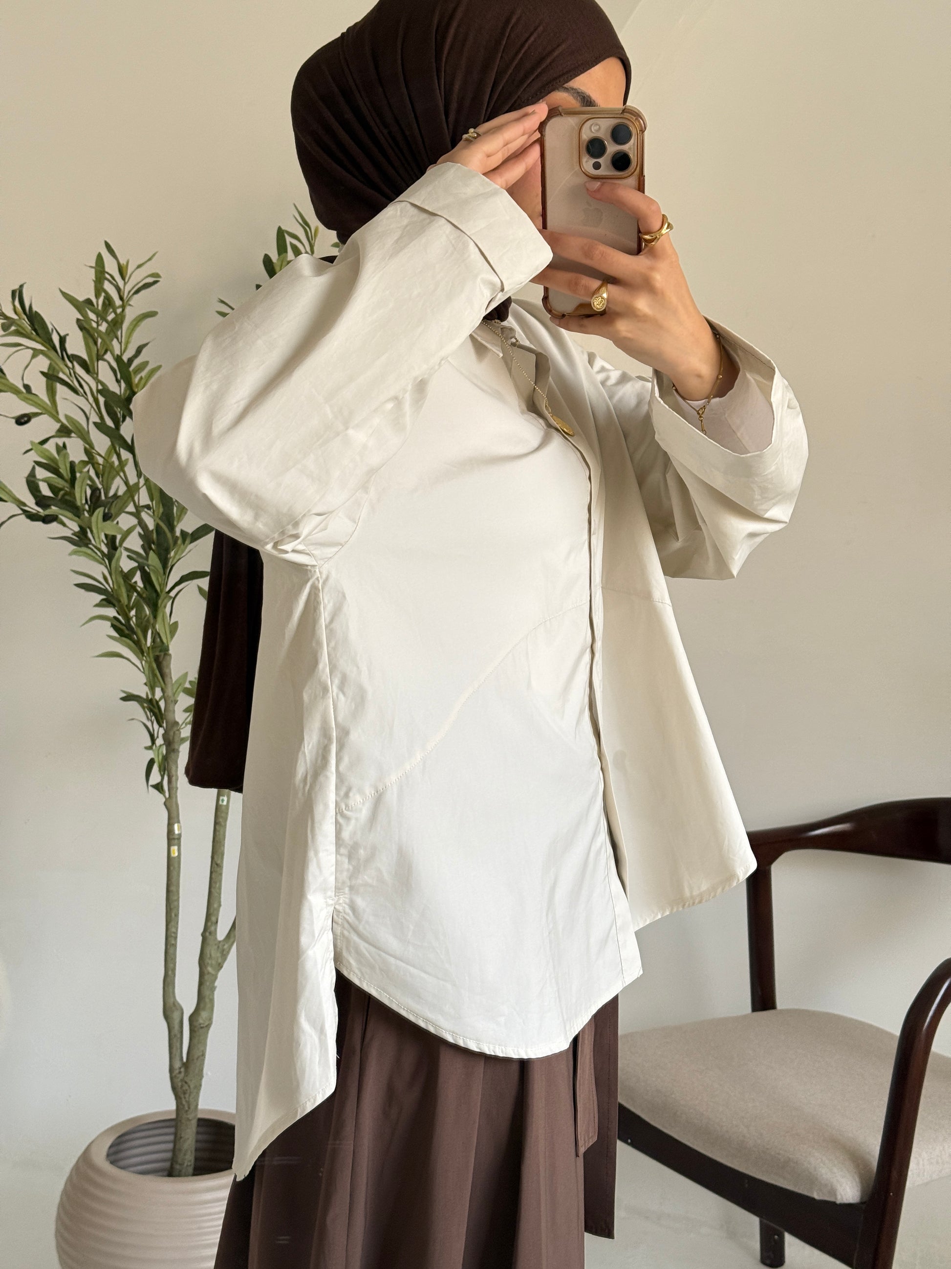 Amenaa oversized poplin shirt in a relaxed fit, featuring a crisp white fabric and classic collar, displayed on a hanger.