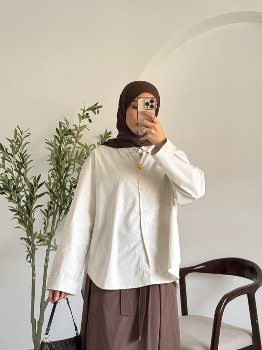 Amenaa oversized poplin shirt in a relaxed fit, featuring a classic collar and button front, shown in a neutral color.