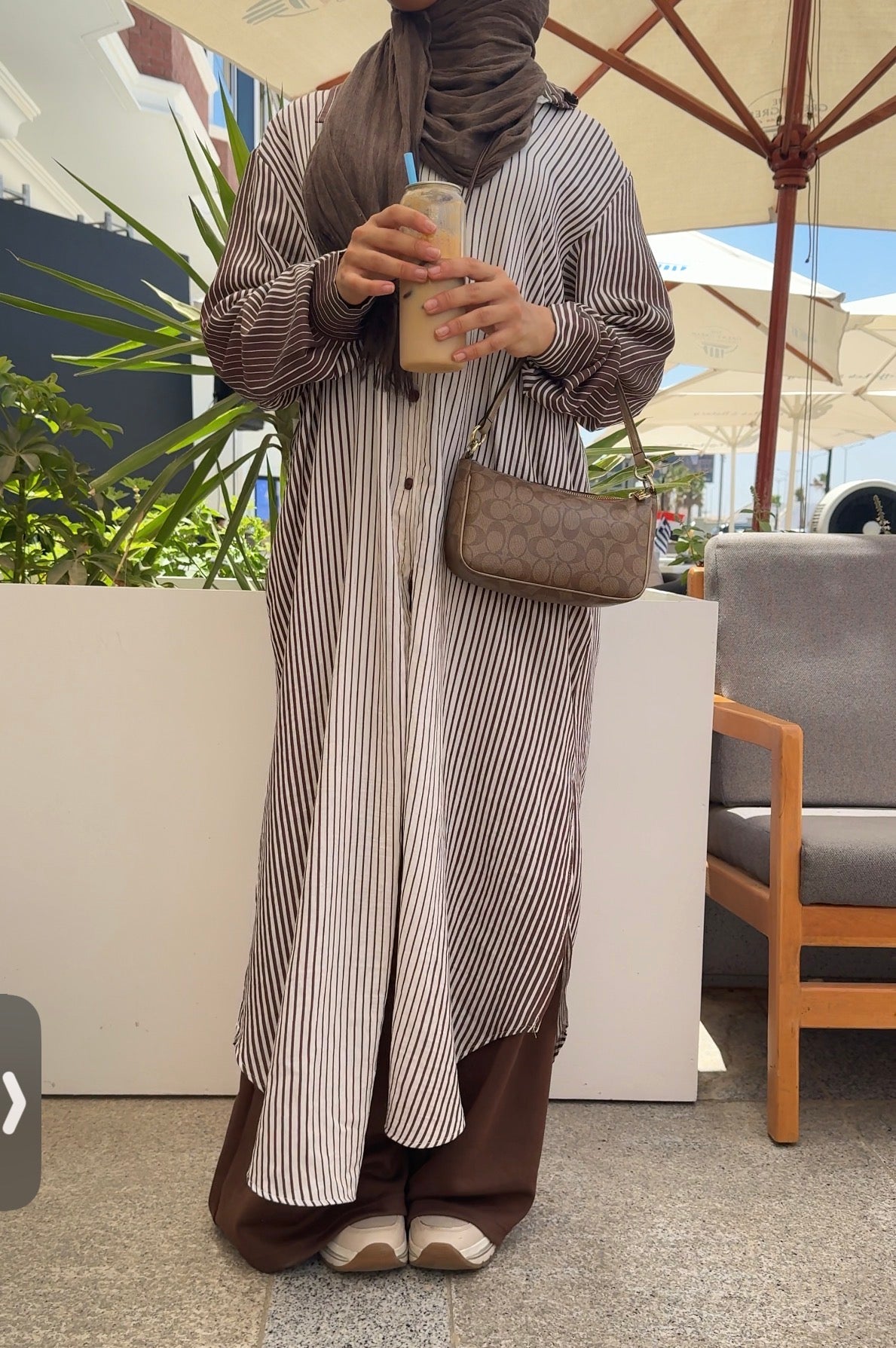 Amenaa long striped shirt featuring a relaxed fit with horizontal navy and white stripes, displayed on a model.