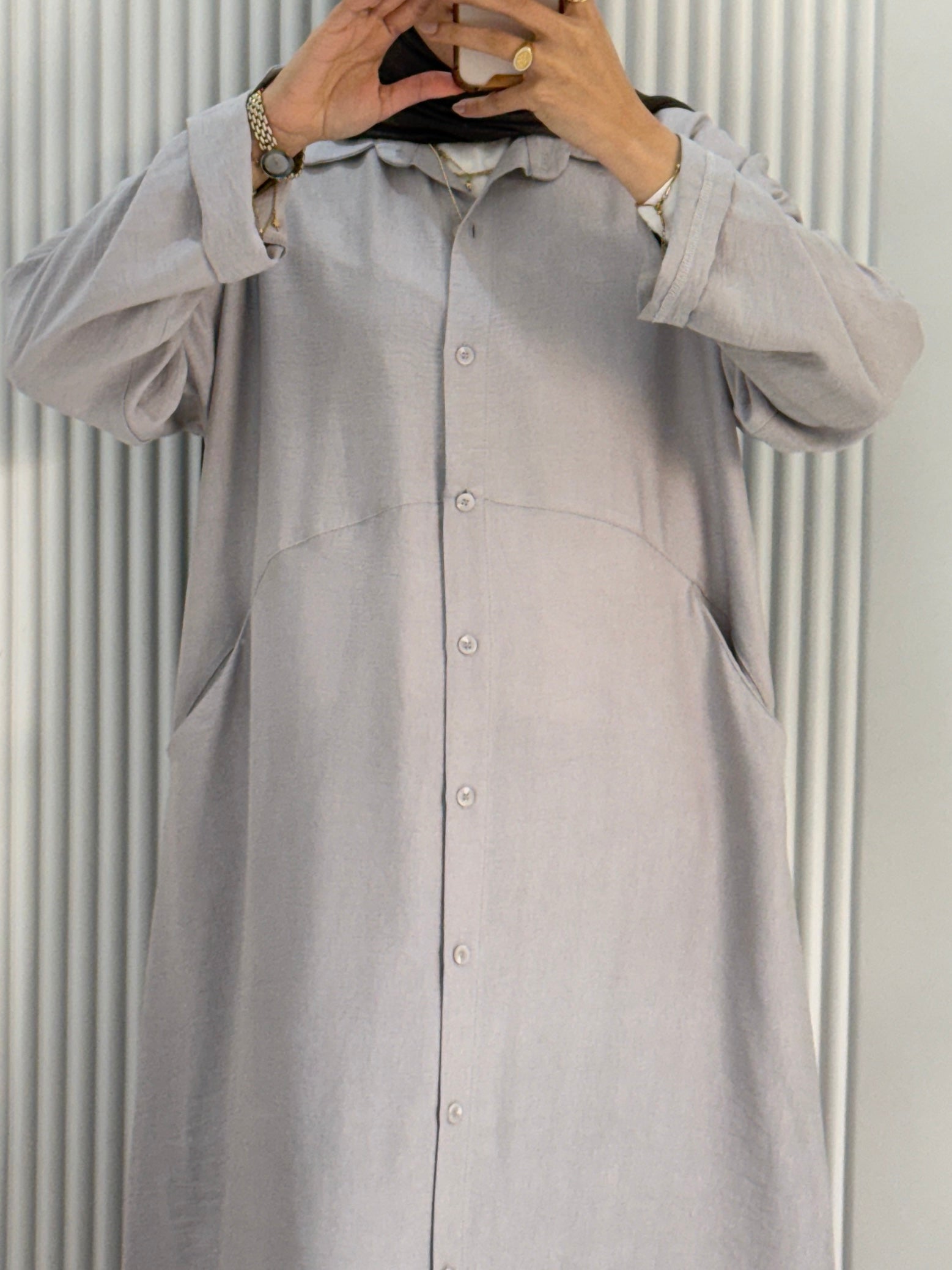 Grey Amenaa shirt dress hanging on a wooden hanger, showcasing a casual and stylish women's dress with a relaxed fit.