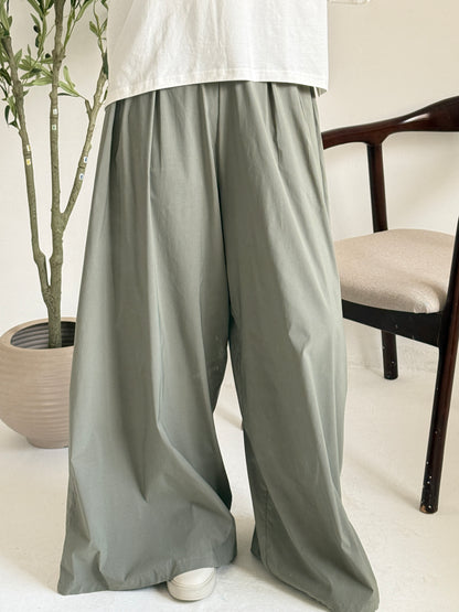 Amenaa wide leg pants in beige fabric, featuring a relaxed fit and high waist, displayed laid flat.