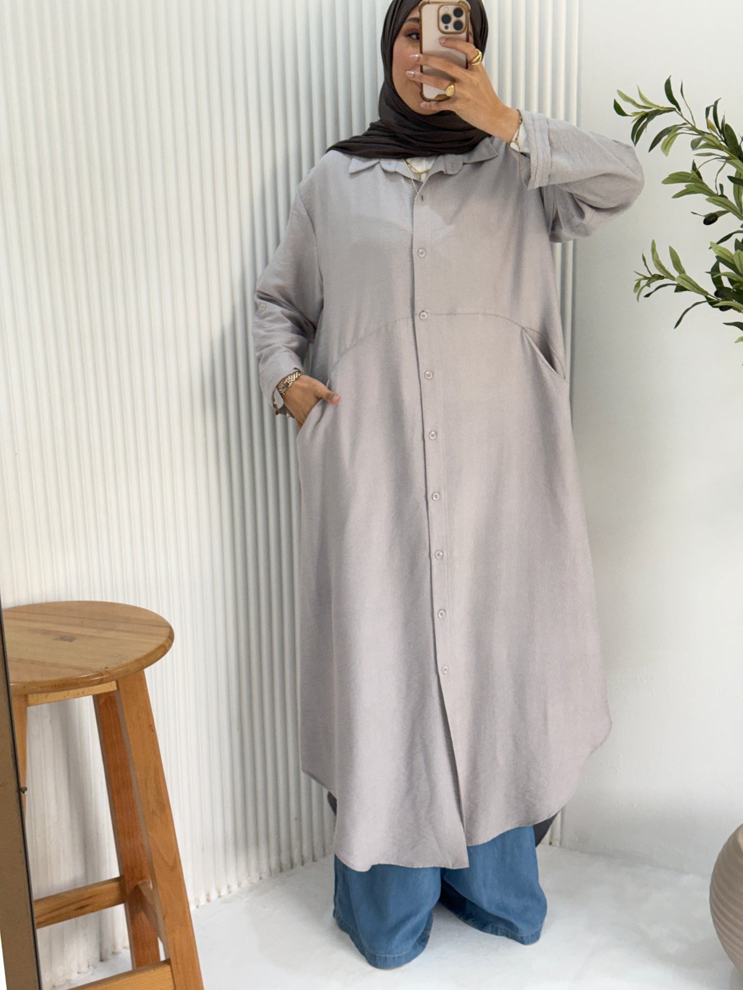 Amenaa grey shirt dress displayed on a hanger, showcasing its relaxed fit and classic button-down design.