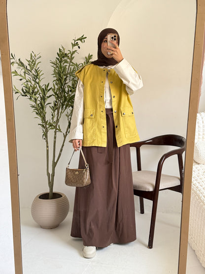 Amenaa new gabardine vest displayed on a hanger, showcasing its tailored fit and classic design in neutral fabric.