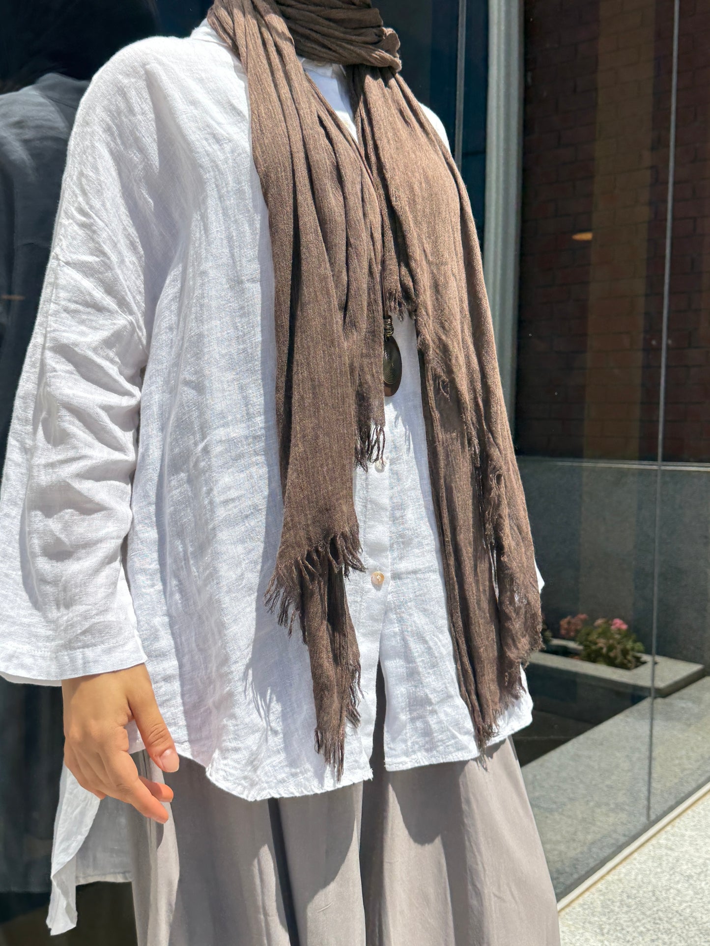 Light beige Amenaa linen shirt, featuring a relaxed fit with long sleeves and a classic collar, displayed on a neutral background.