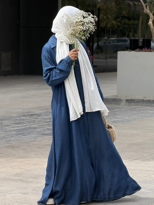 Amenaa maxi denim dress displayed on a hanger, showcasing its flowing fabric and casual style perfect for everyday wear.