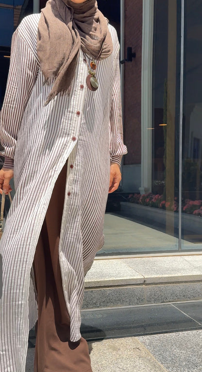 Long striped shirt by Amenaa displayed on a mannequin, featuring a casual fit with vertical navy and white stripes.