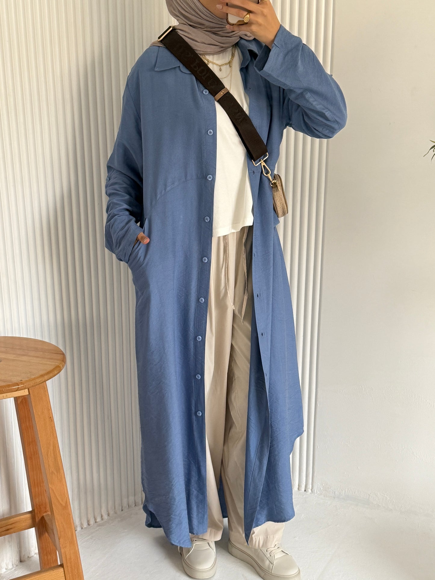 Amenaa shirt dress displayed on a hanger, featuring a classic collar, button-down front, and a relaxed fit in lightweight fabric.