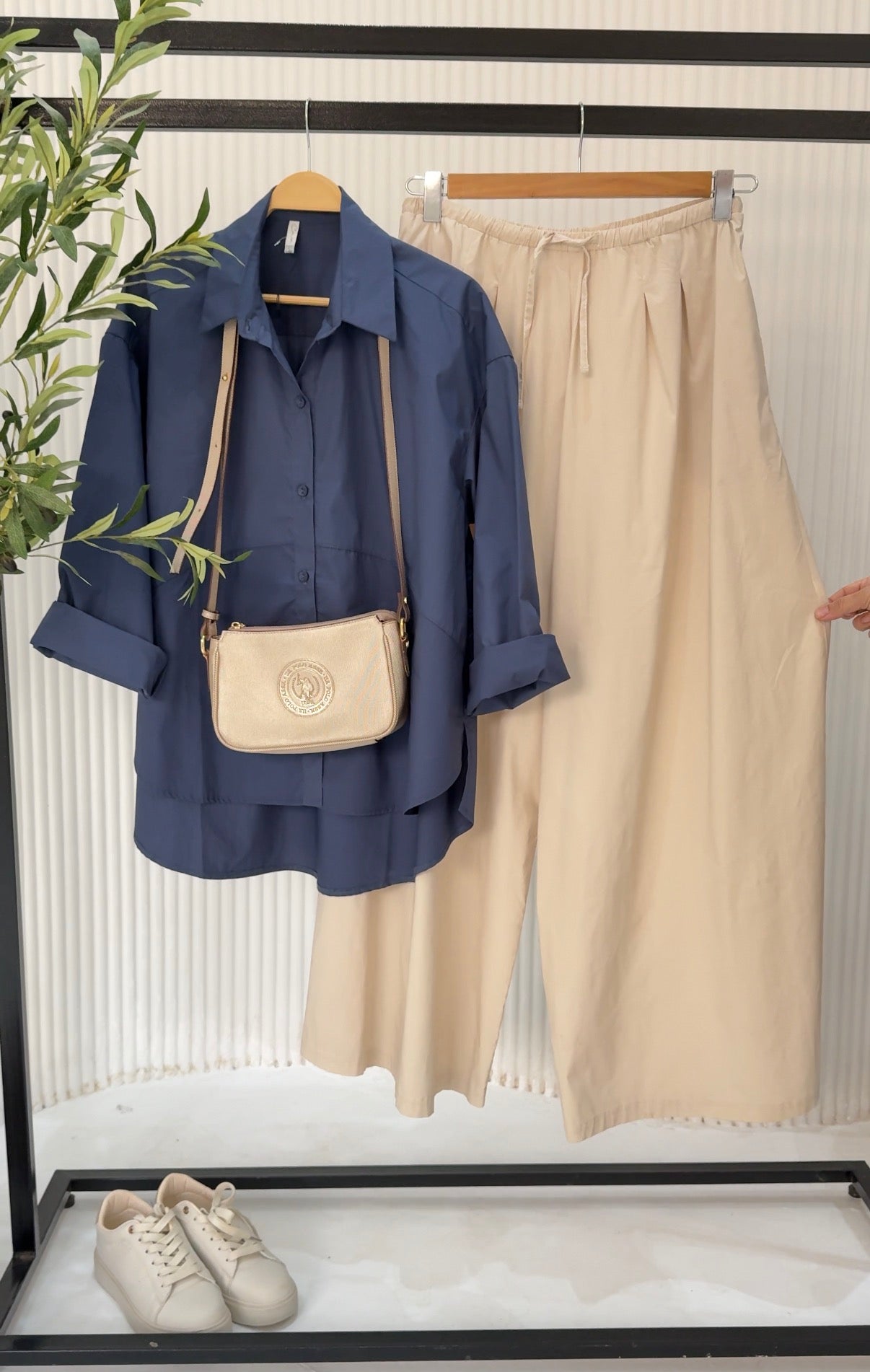 Amenaa oversized poplin shirt displayed flat, showing its relaxed fit, collar, and long sleeves on a neutral background.