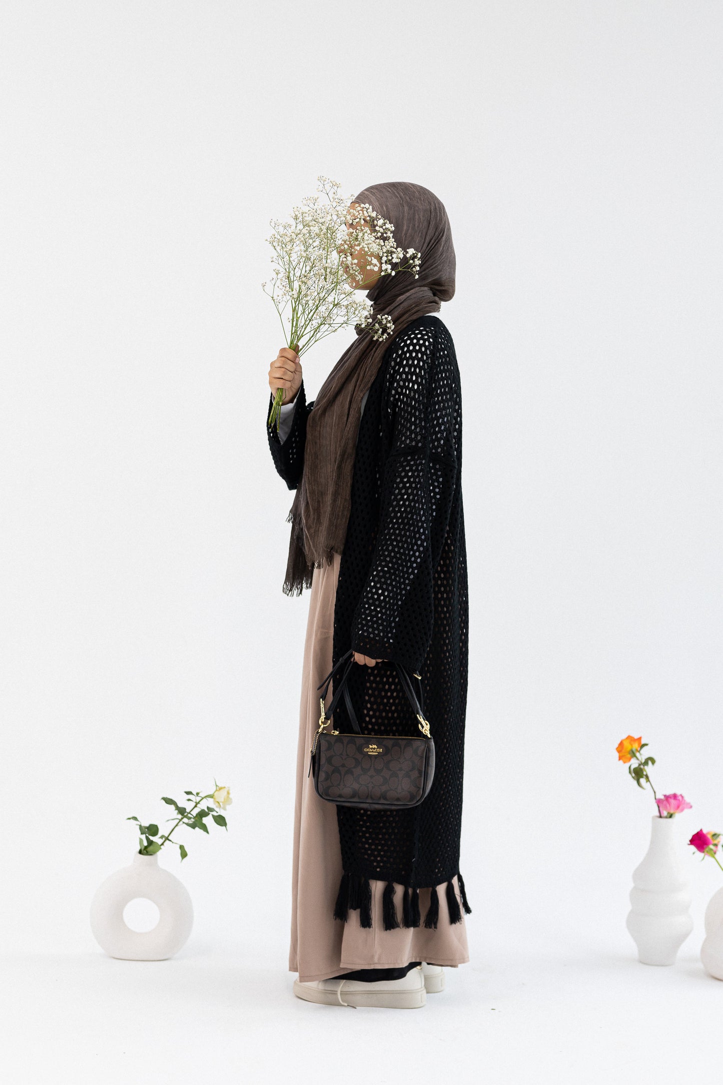 Crochet knit cardigan from Amenaa featuring a cozy, textured design in soft, neutral tones.