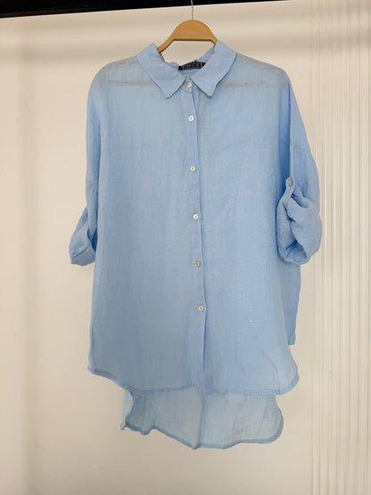 Light beige Amenaa linen shirt with long sleeves and a relaxed fit, displayed on a hanger against a neutral background.