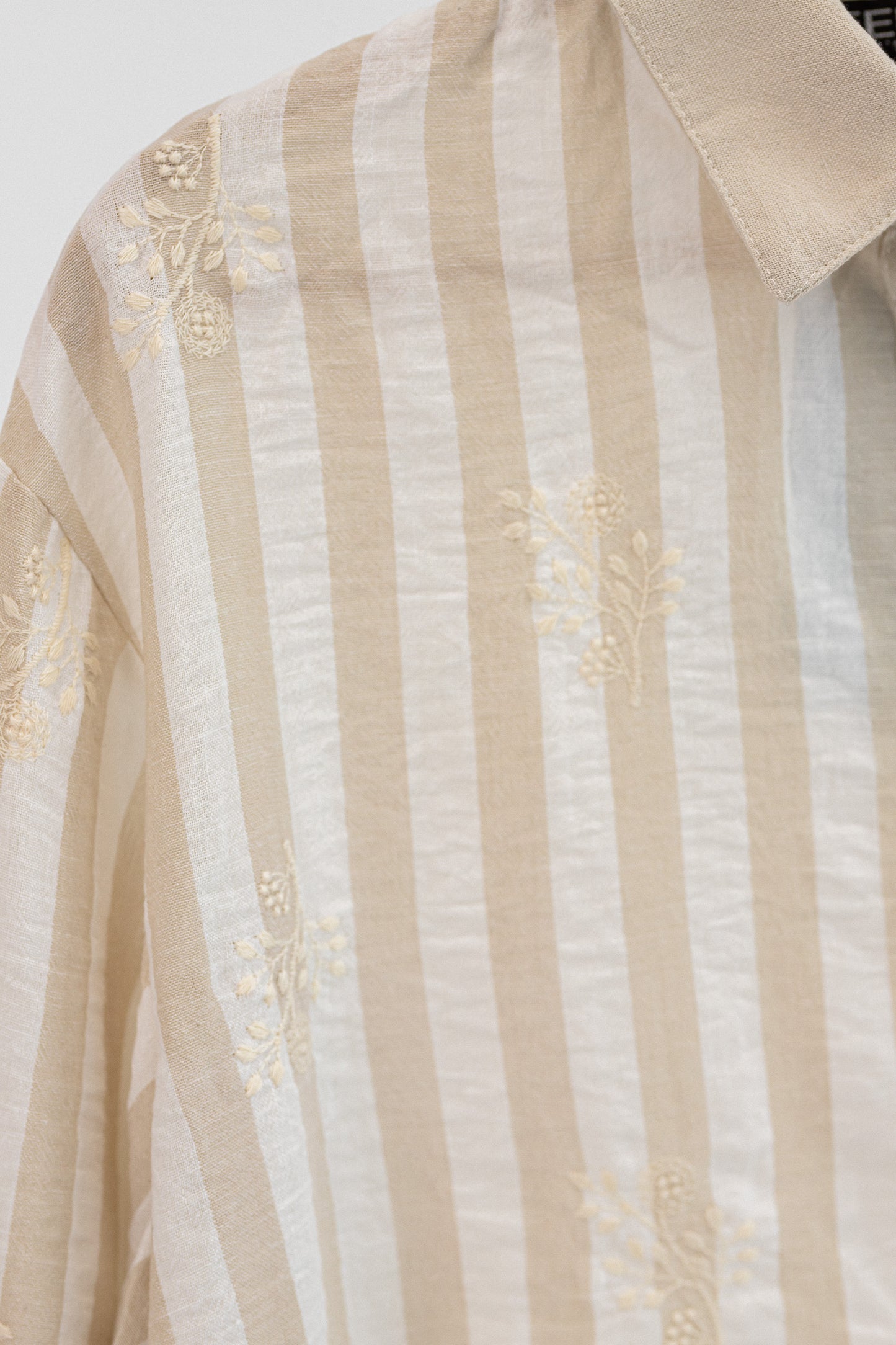 Amenaa striped embroidered shirt with colorful patterns, featuring a classic button-up design and collar detail.