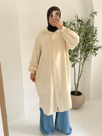 Long beige chemise by Amenaa, flowing lightweight sleepwear with thin shoulder straps and a relaxed fit, displayed on a hanger.