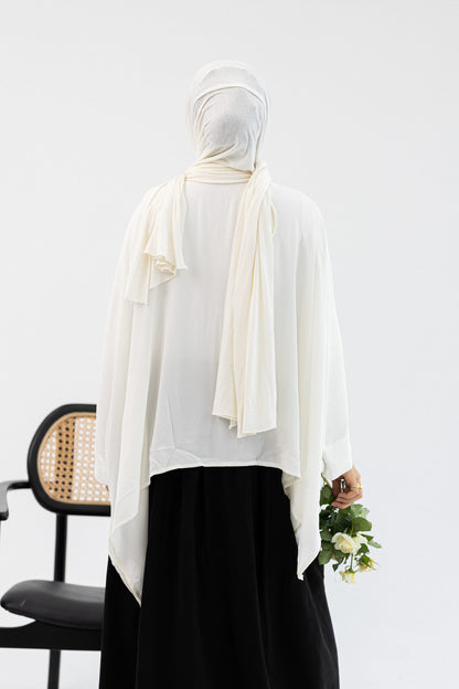 Amenaa ruffles blouse with long sleeves and feminine ruffle details, displayed on a neutral background.