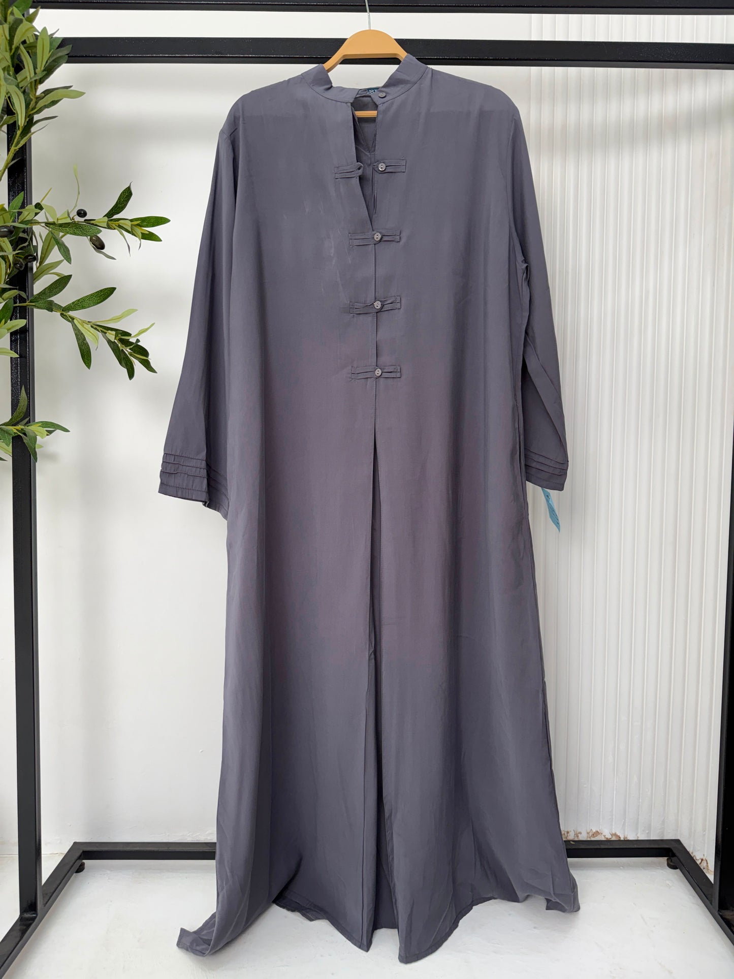Amenaa Modest Tencel Dress displayed on a hanger, featuring a flowing, lightweight fabric with a simple, elegant design.
