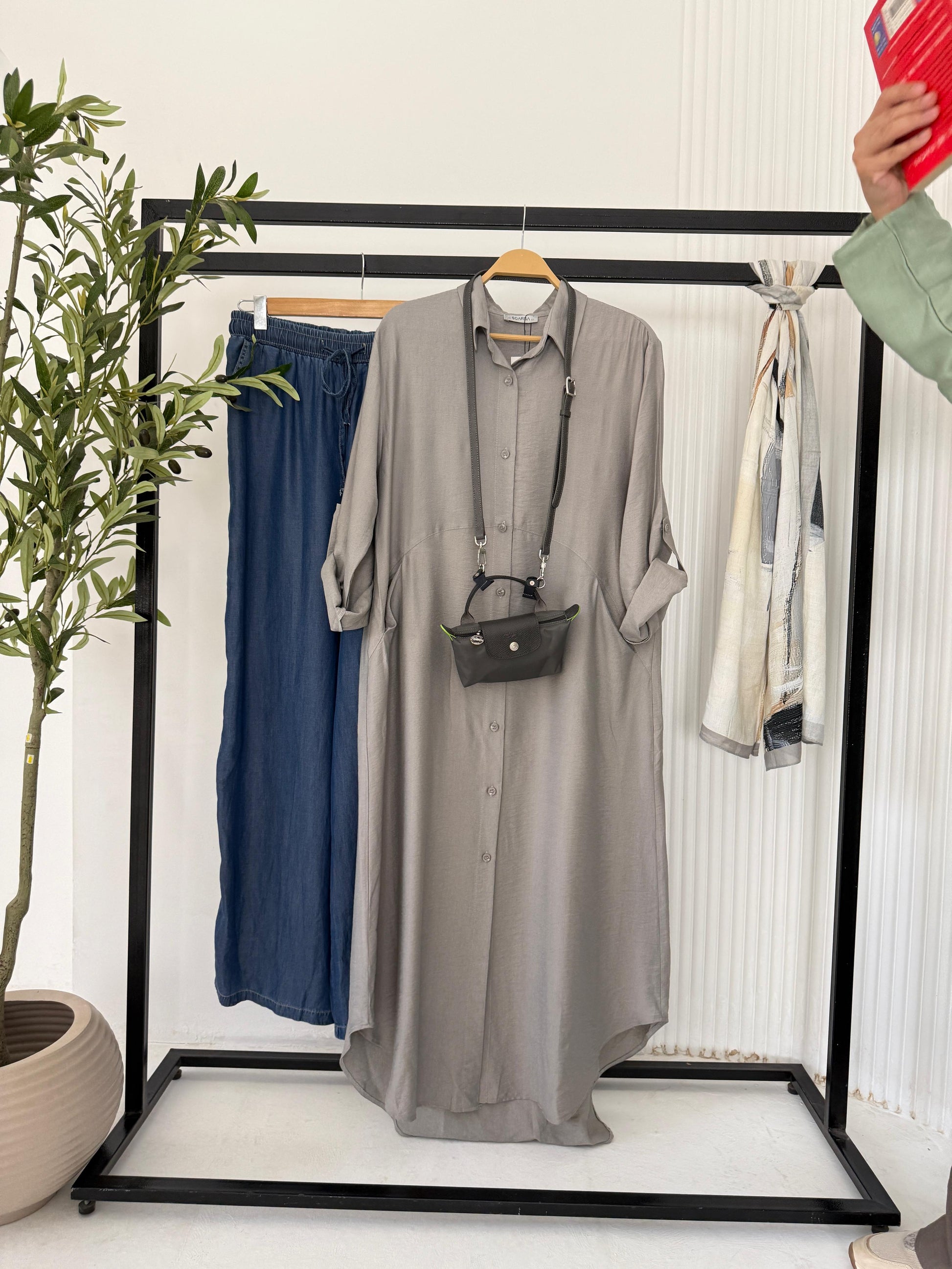 Amenaa shirt dress with a relaxed fit, featuring a collar, button-front, and short sleeves on a casual outdoor setting.