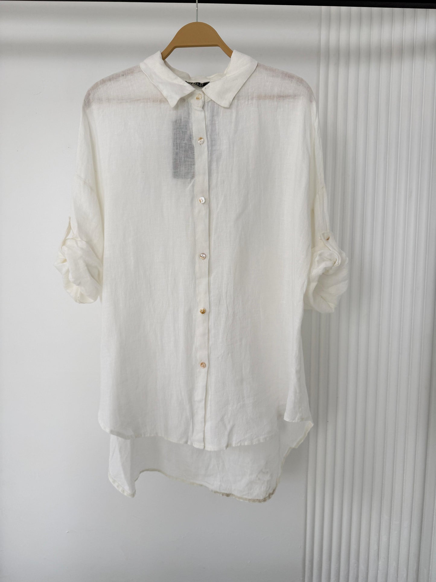 Light beige Amenaa linen shirt with long sleeves and a relaxed fit, displayed flat on a white background.