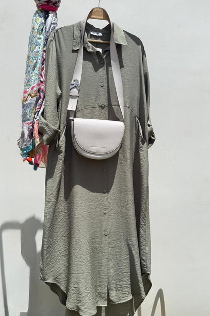Amenaa shirt dress with a relaxed fit, featuring a collar, button details, and a knee-length design, shown on a model.