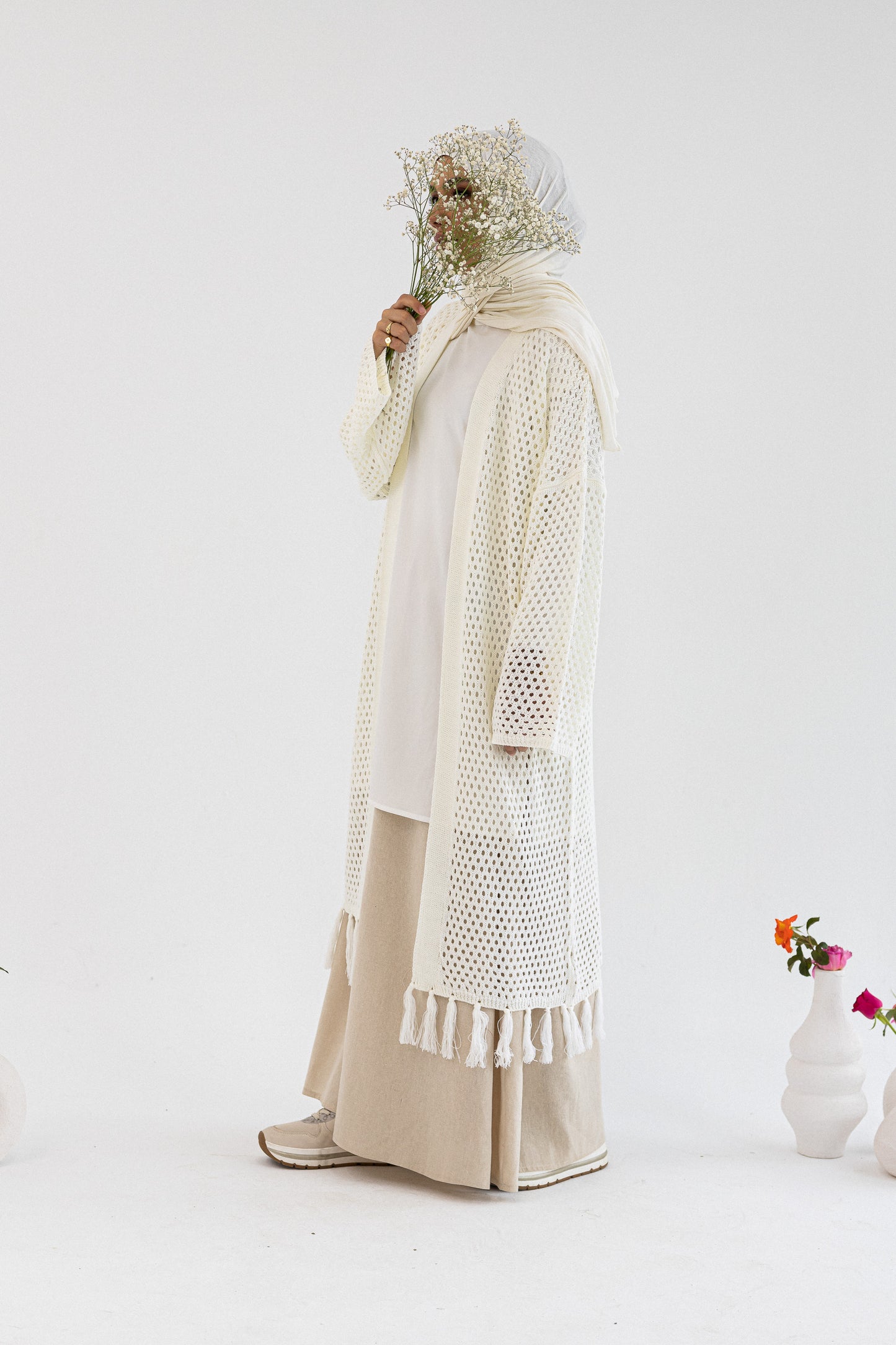 Amenaa crochet knit cardigan in beige, featuring a textured, open-knit design with long sleeves and a cozy, stylish fit.
