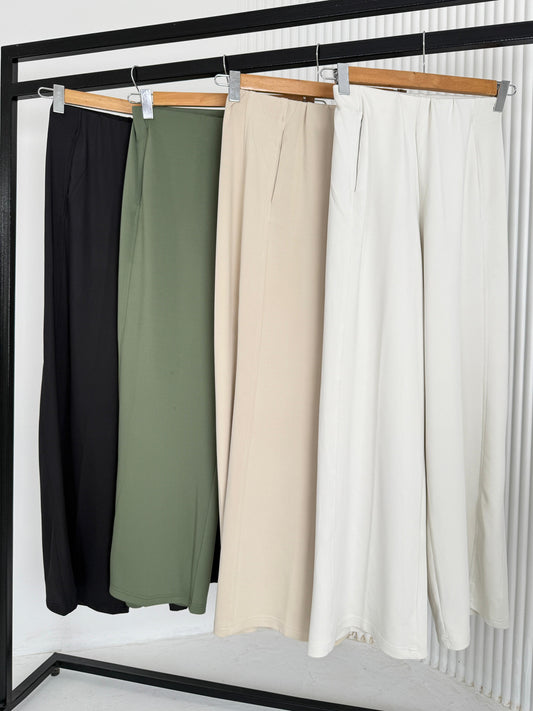 Flow Wide-Leg Pants by Amenaa, showing the relaxed fit and drape of the lightweight fabric in a neutral color.