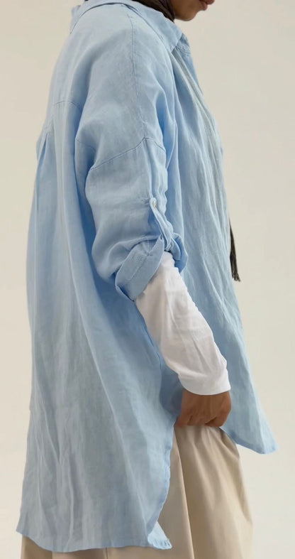 Amenaa linen shirt displayed on a hanger, showcasing lightweight, breathable fabric with a relaxed fit and classic collar.