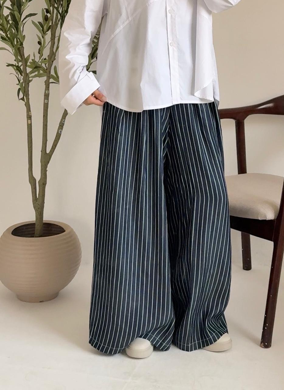 Wide leg striped pants by Amenaa featuring a relaxed fit, high waist, and bold vertical stripes, perfect for casual or chic outfits.
