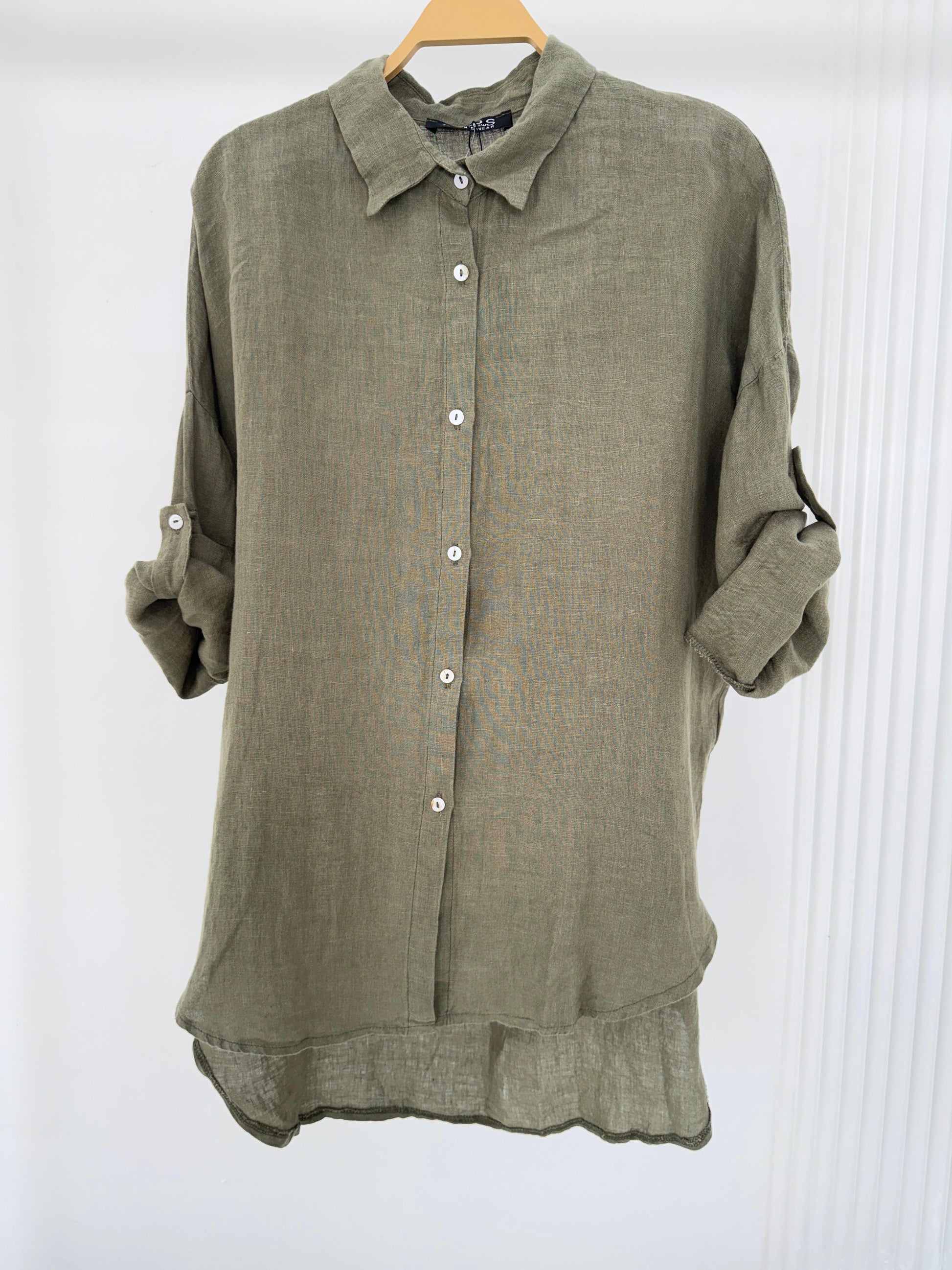 Amenaa linen shirt displayed on a hanger, showcasing lightweight, breathable fabric with a relaxed fit and classic collar.