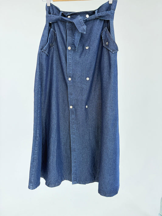 Amenaa button denim skirt shown on a model, featuring a high-waisted fit and classic button front design.