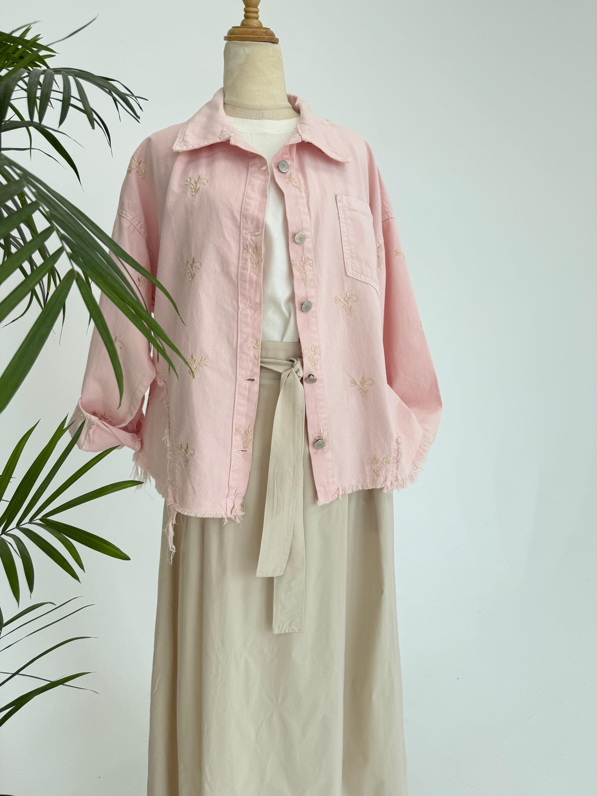 Flowery embroidered Amenaa gabardine jacket with detailed floral patterns and a tailored fit, displayed on a hanger.