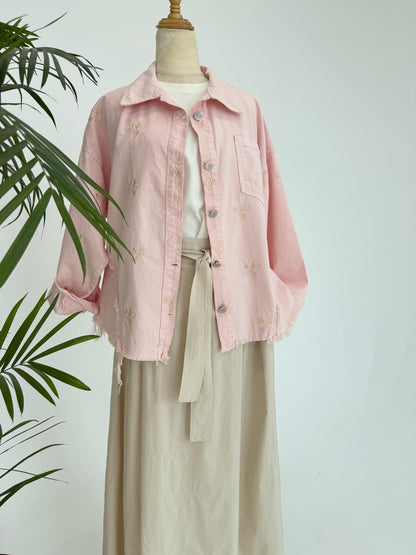 Flowery embroidered Amenaa gabardine jacket with detailed floral patterns and a tailored fit, displayed on a hanger.