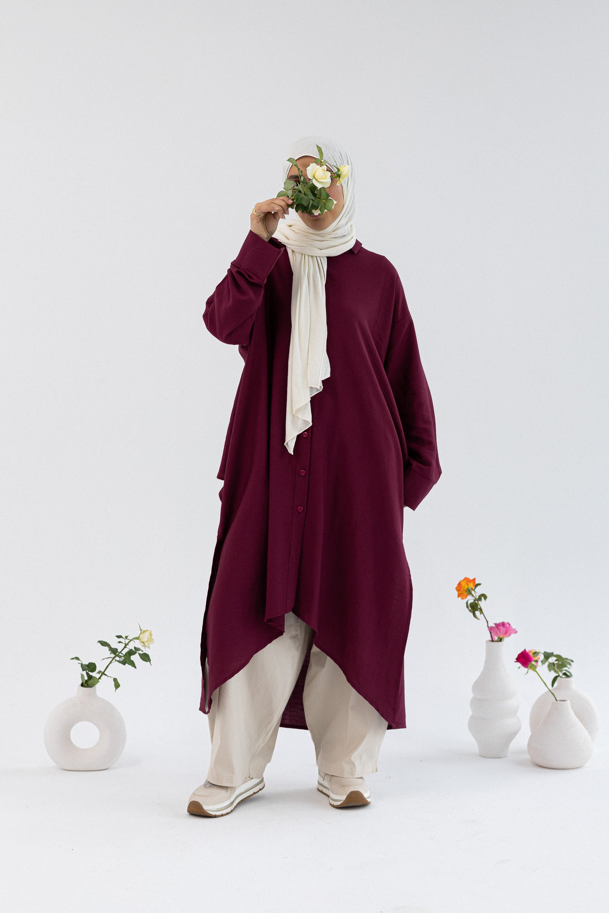 Amenaa high-low shirt dress featuring a relaxed fit, button-down front, and collar, ideal for casual or semi-formal wear.