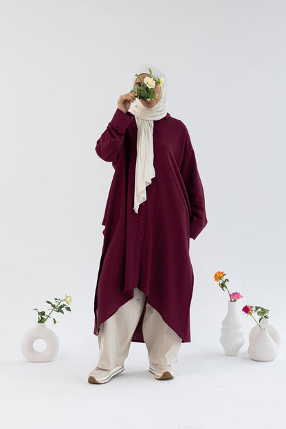 Amenaa high-low shirt dress featuring a relaxed fit, button-down front, and collar, ideal for casual or semi-formal wear.