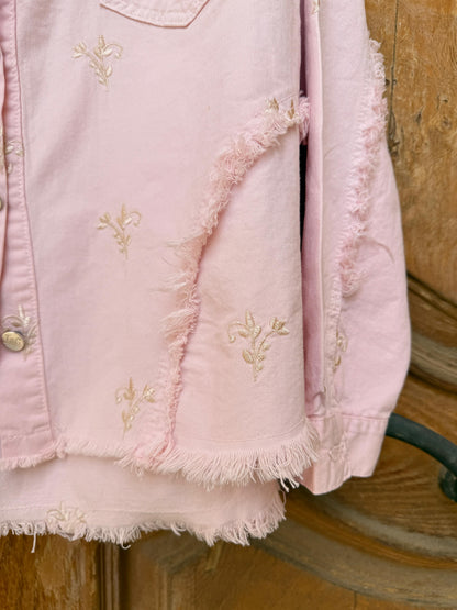 Flowery embroidered gabardine jacket by Amenaa featuring colorful floral patterns and tailored fit, displayed on a hanger.