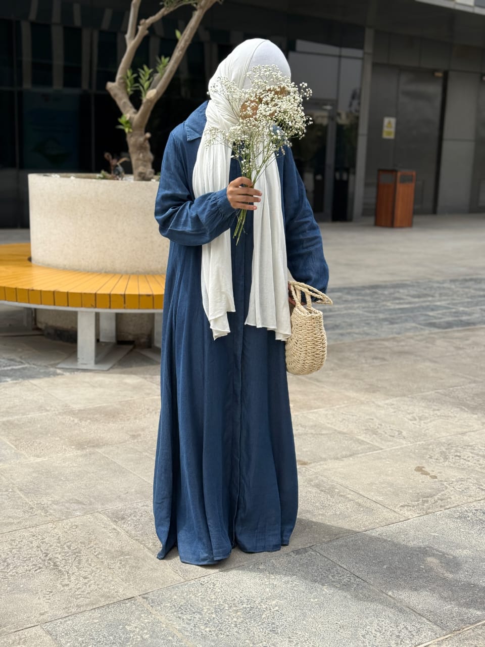Amenaa maxi denim dress displayed on a hanger, showcasing its long, sleeveless design and casual denim fabric.