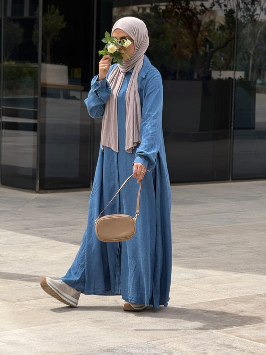 Amenaa maxi denim dress displayed on a model, featuring a sleeveless design, fitted bodice, and flowing skirt for a casual-chic look.