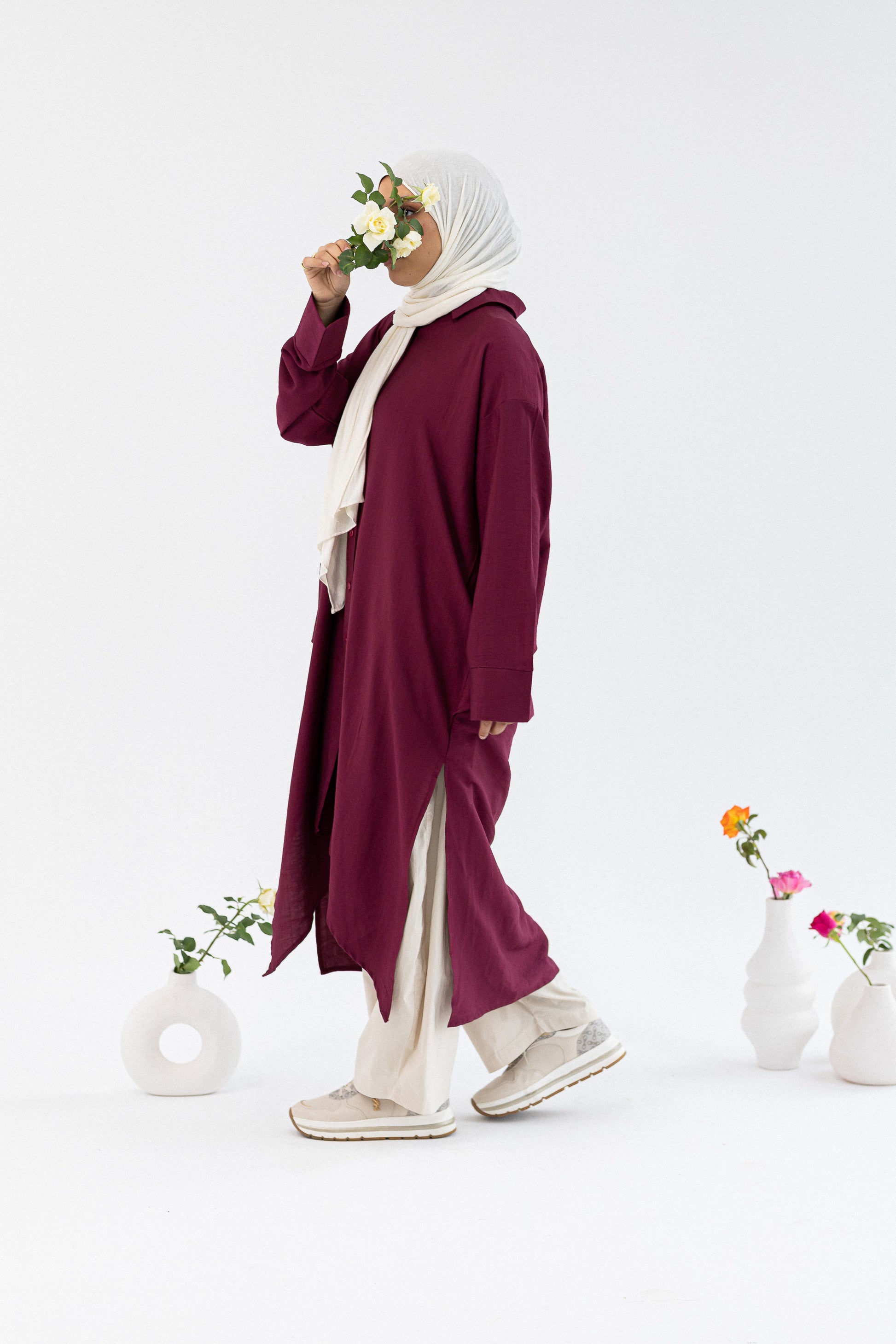 Amenaa high-low shirt dress featuring a flowy design with a collar, long sleeves, and a flattering hemline.