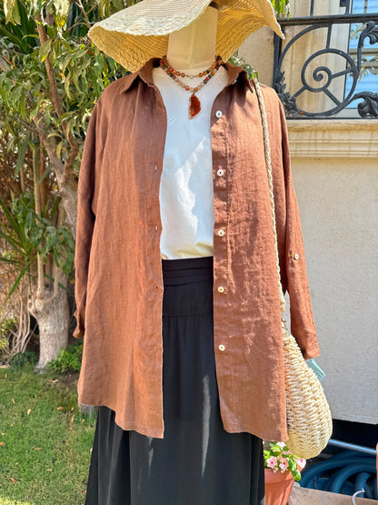 Men's linen shirt by Amenaa, light and breathable fabric with a relaxed fit, displayed on a hanger.