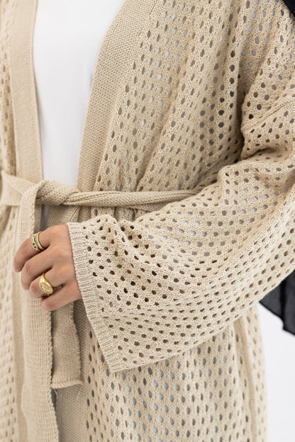 Cream crochet knit cardigan from Amenaa with a relaxed fit, showcasing intricate stitch patterns and a cozy, stylish design.