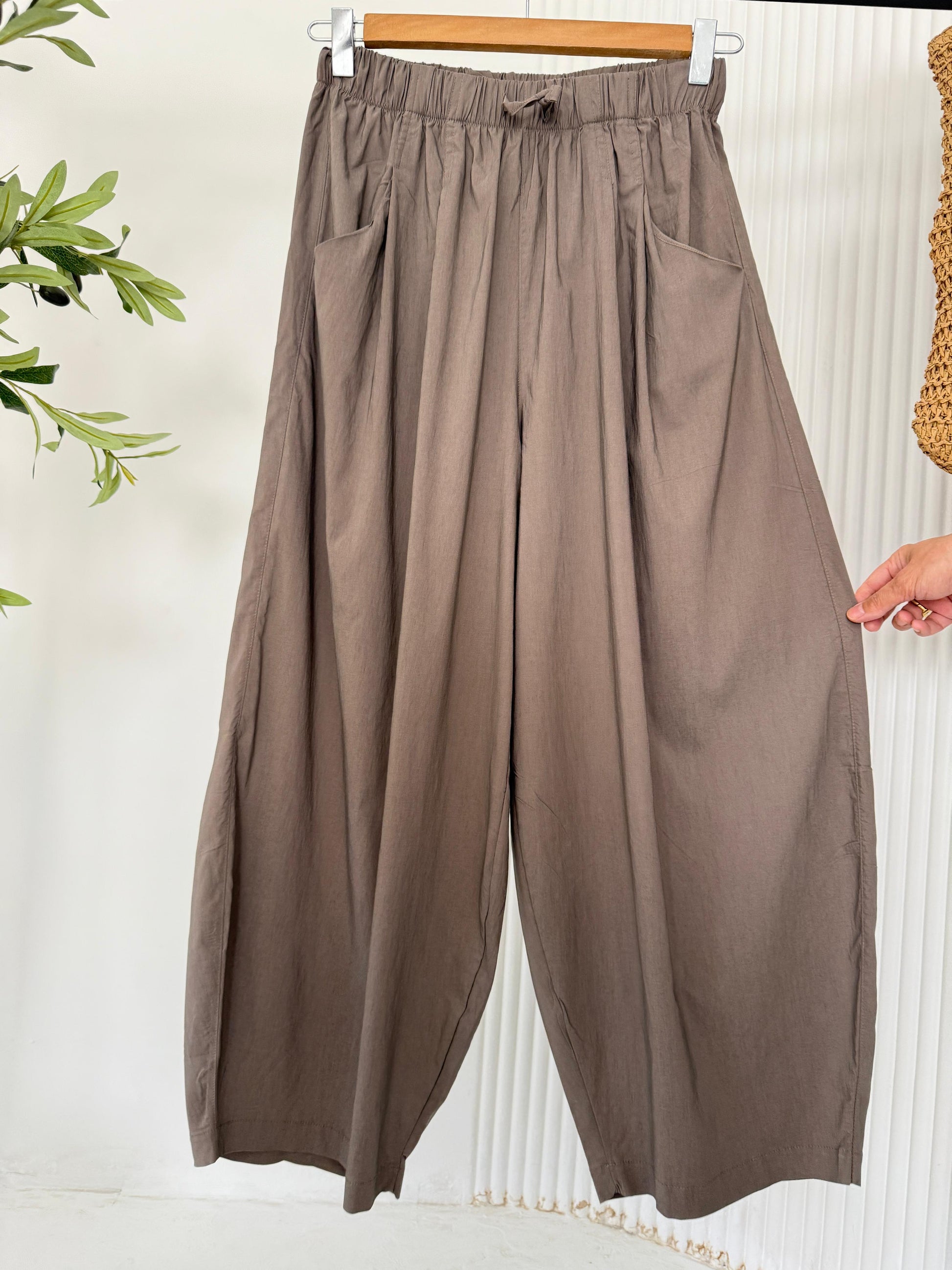 Amenaa balloon pants featuring a loose fit and gathered waistband, shown in a lightweight fabric with a relaxed, stylish silhouette.